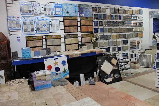 Showroom display wall of pool tile, coping and paver samples